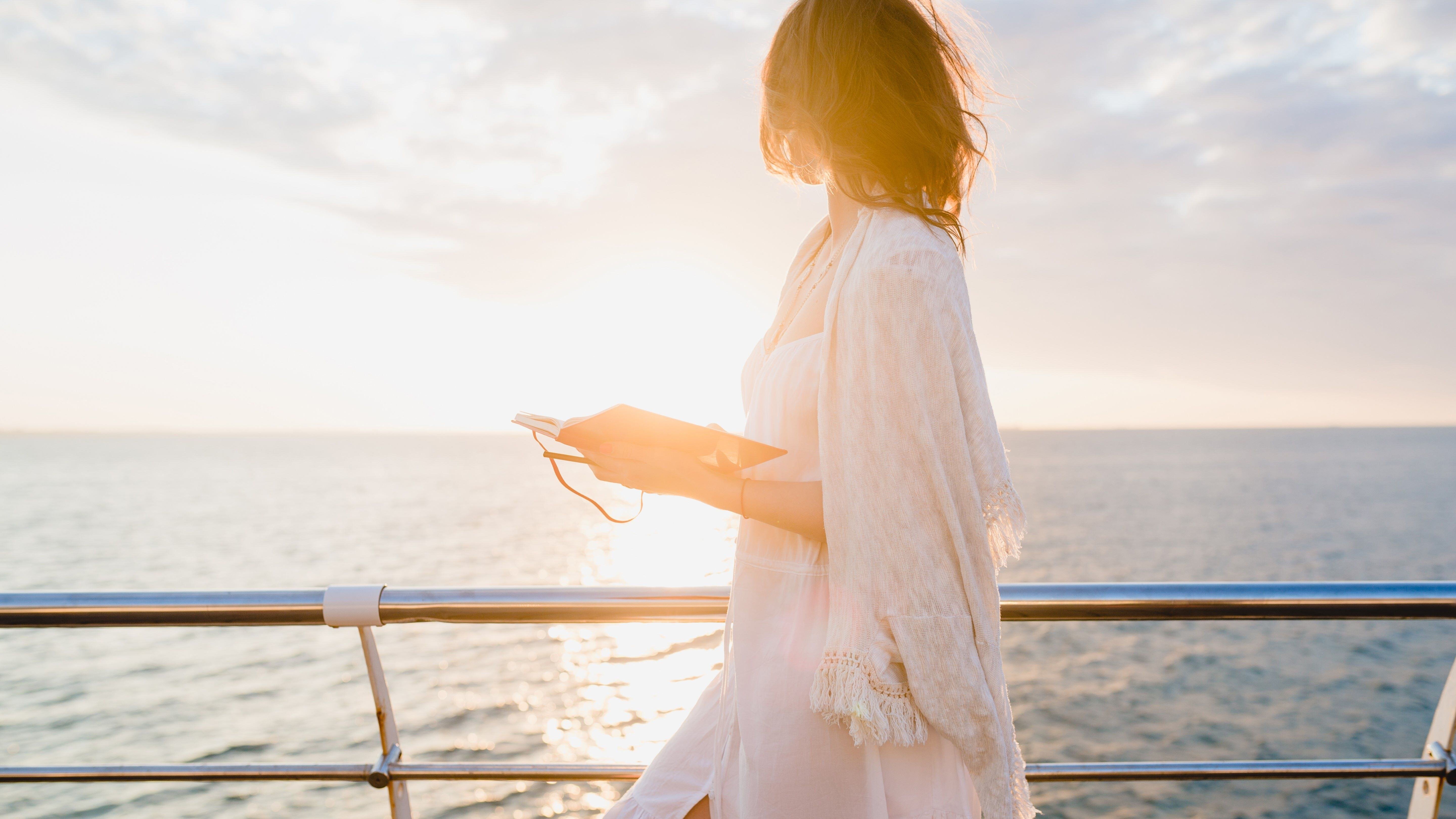 beautiful-woman-white-summer-dress-walking-by-sea-sunrise-with-diary-book-romantic-mood-thinking-making-notes