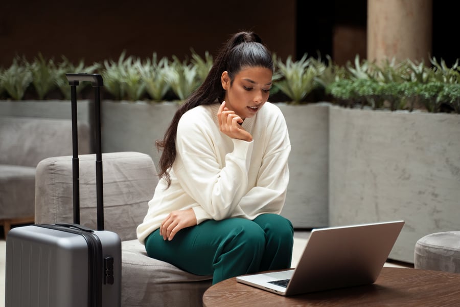 woman working on her own travel business on computer